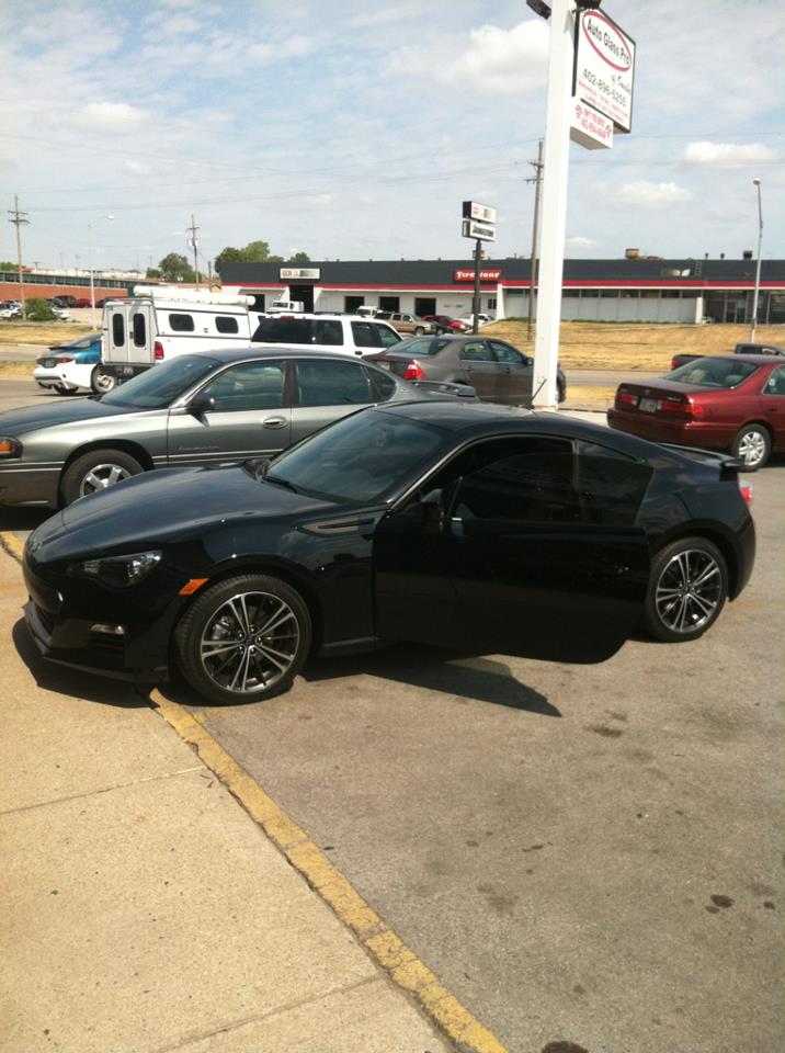A black car in a parking lot