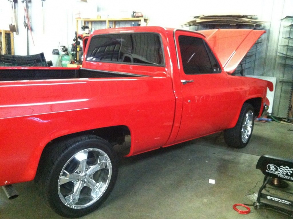 A vintage red truck with it's hood up